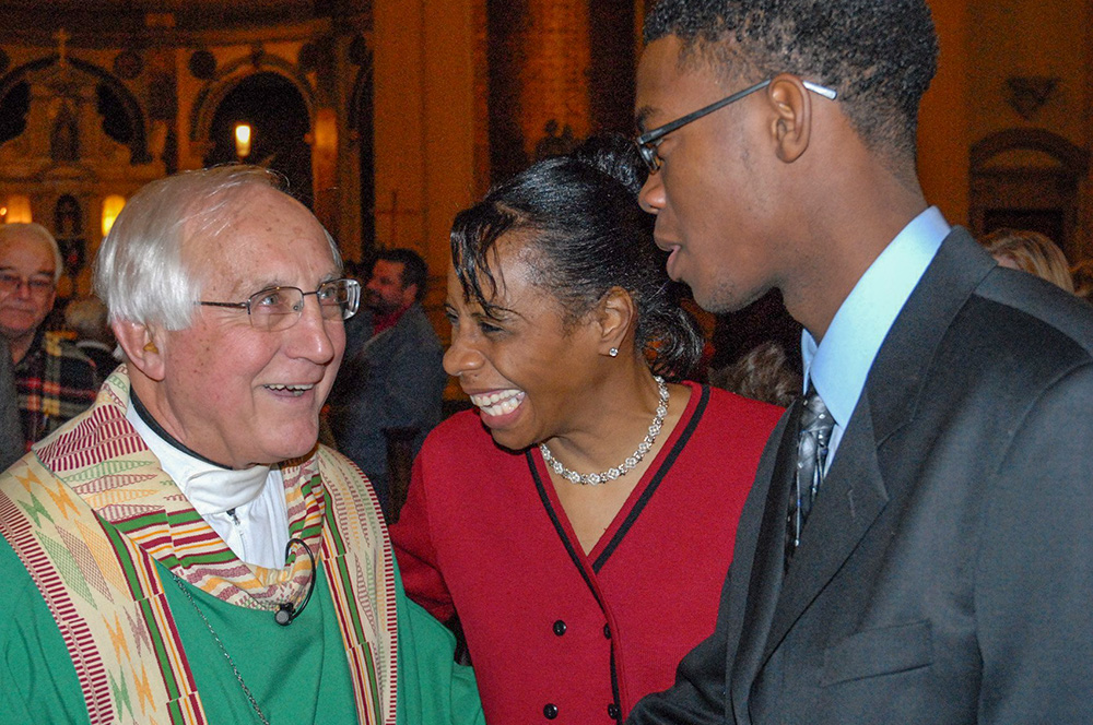 Retired Auxiliary Bishop Thomas Gumbleton talks with longtime parishioners Linda Maxwell and her nephew, Wesley Maxwell, Jan. 21, 2007, at his last Mass as administrator of St. Leo Parish in Detroit. (OSV News/Michigan Catholic file photo/Robert Delaney)