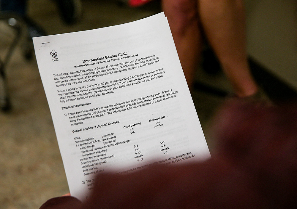 A person holds a consent form for testosterone therapy during an appointment at Oregon Health & Science University's Doernbecher Gender Clinic in Portland, Oregon, May 10, 2022. (OSV News/Reuters/Lindsey Wasson)