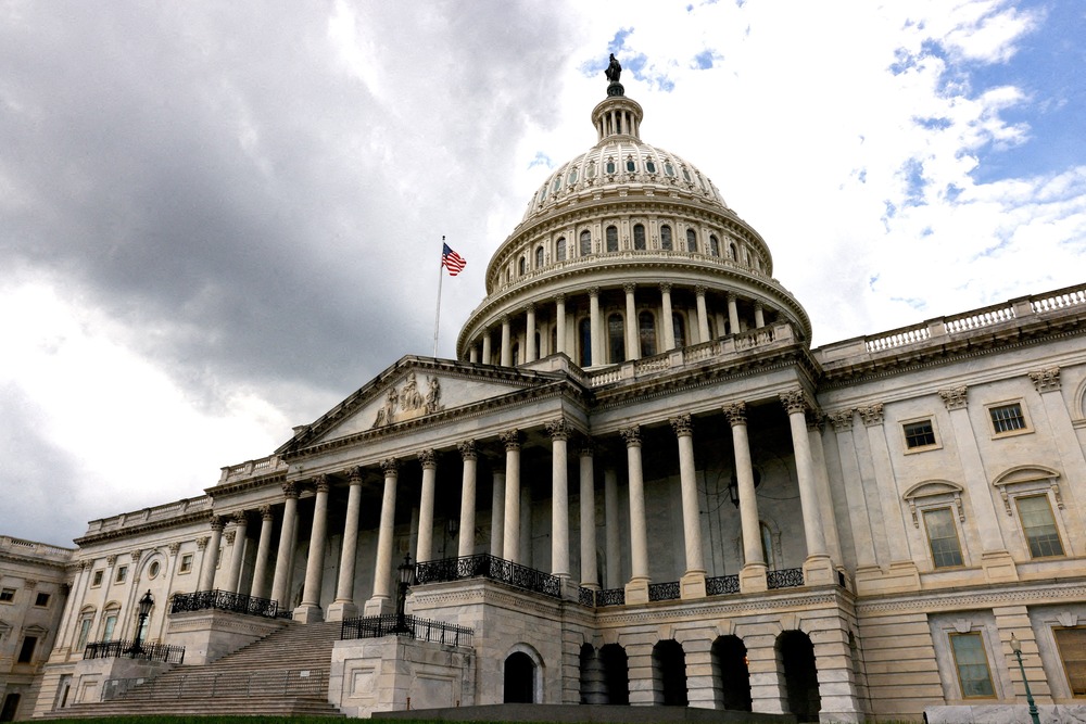 Ukraine, Israel aid bill. Looming edifice of U.S Capitol, darkened by overcast skies.