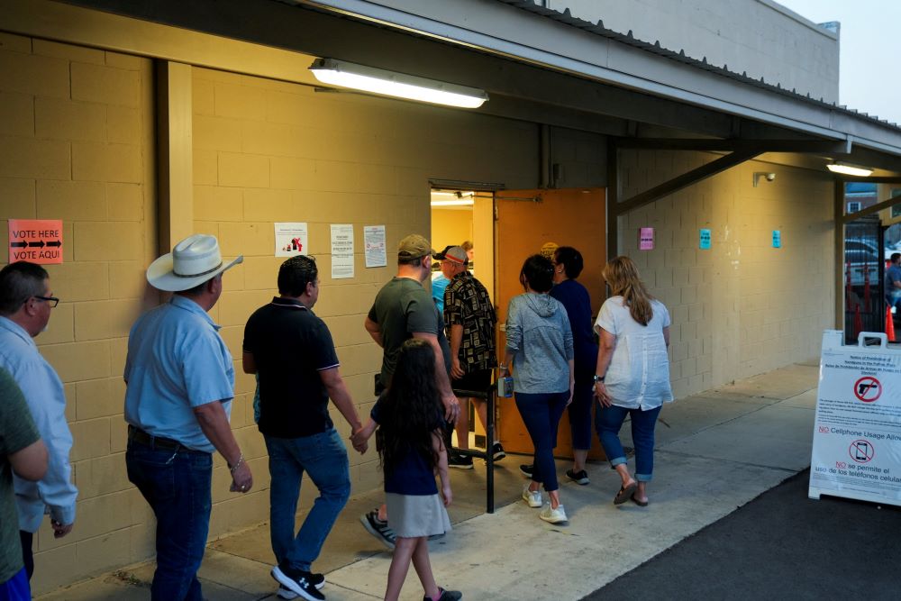 People stand in a line to vote shortly before the polls close in Edinburg, Texas, during the Super Tuesday primary election March 5.