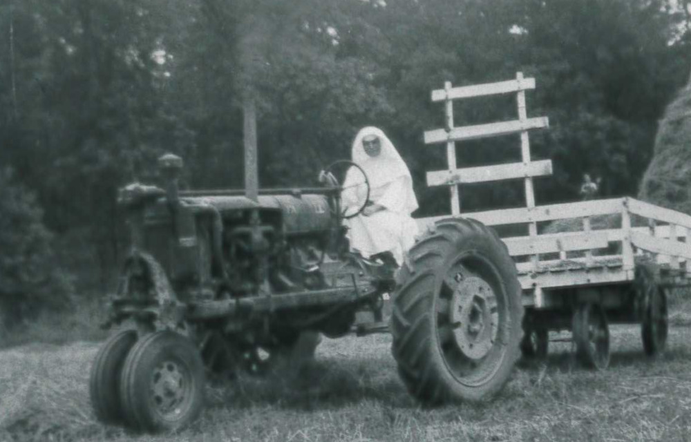 Sisters have been farming their property in Sinsinawa, Wisconsin, since the congregation was founded in 1847. Here, a sister rides a tractor in a haying field in a photo dated August 1947. 