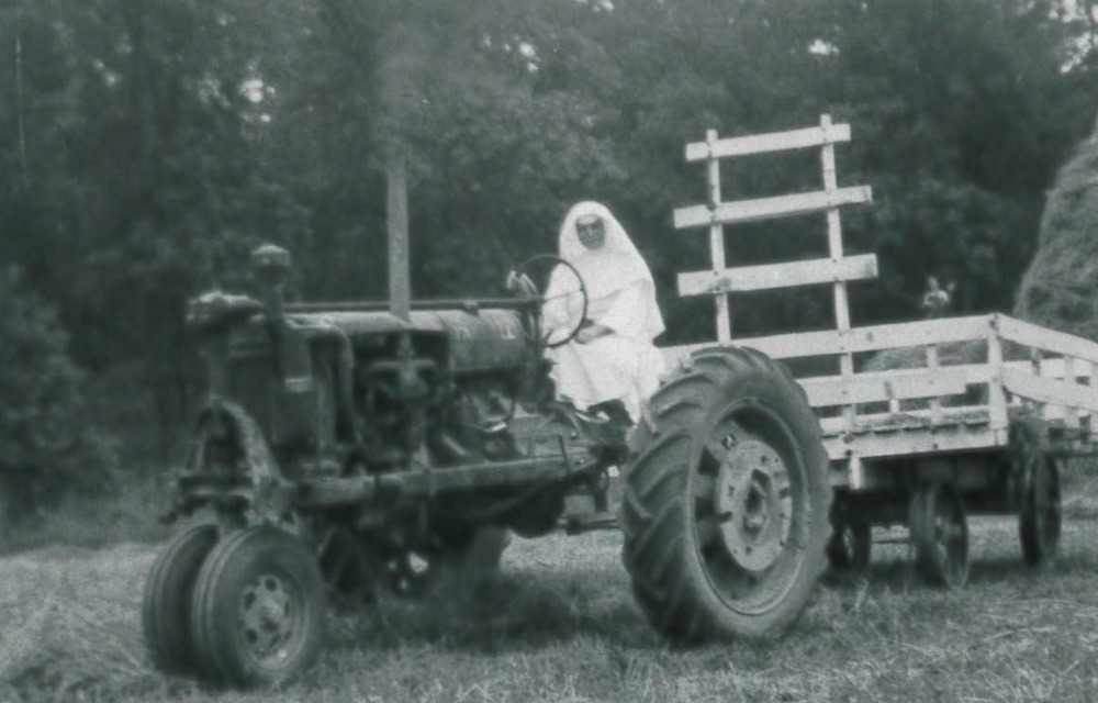 Sisters have been farming their property in Sinsinawa, Wisconsin, since the congregation was founded in 1847. Here, a sister rides a tractor in a haying field in a photo dated August 1947.