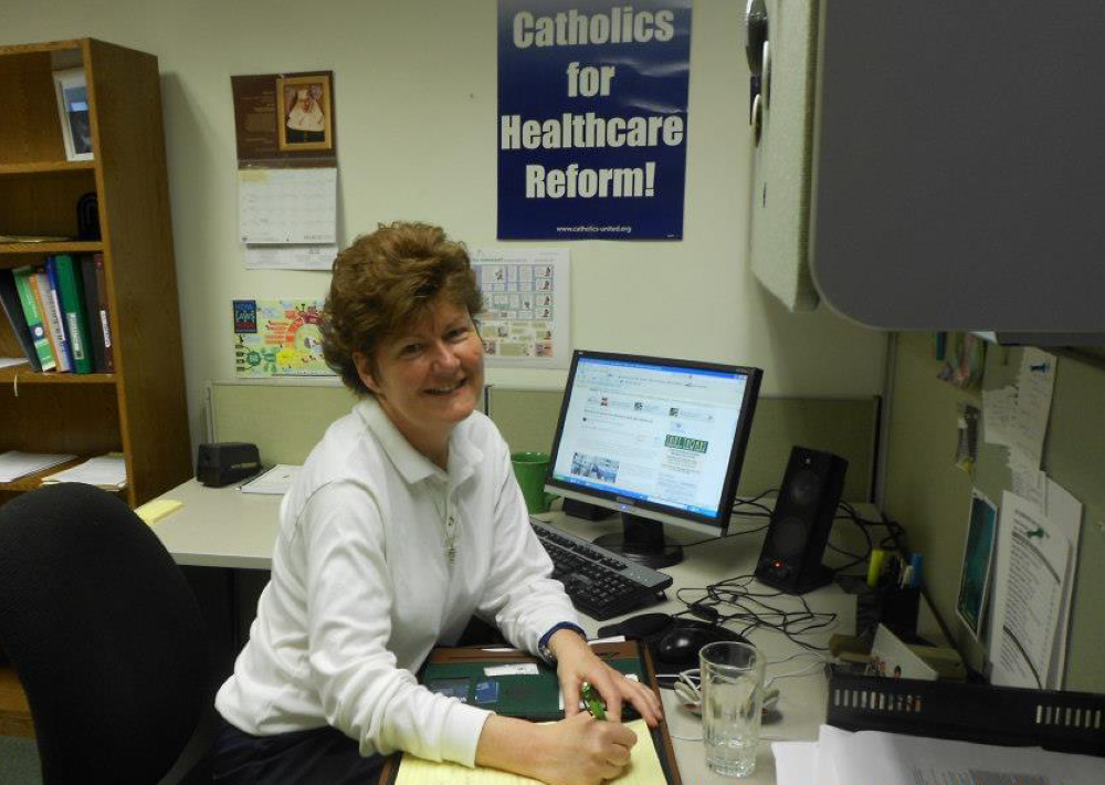 Daughter of Charity Sr. Mary Ellen Lacy sits in her cubicle at Network in 2012.