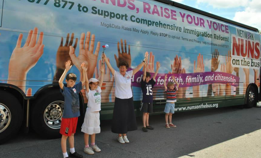 Sr. Mary Ellen Lacy stands outside Network's bus during the 2013 Nuns on the Bus tour for immigration reform.