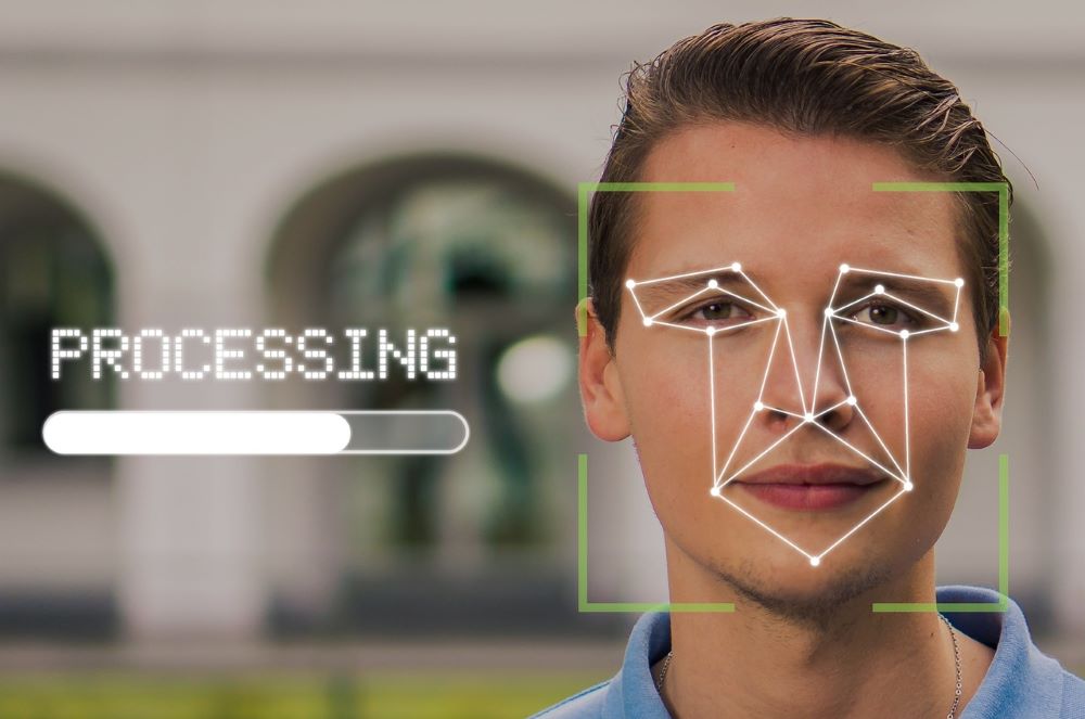 Man's face on a computer screen, with lines representing biometric screening