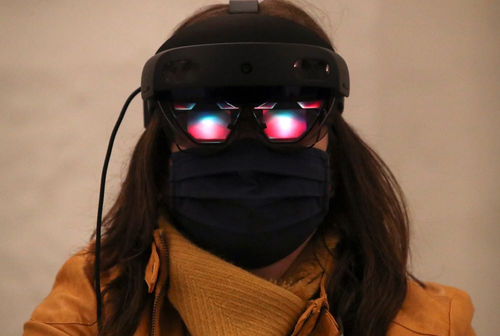 Woman wears virtual glasses using artificial intelligence. 