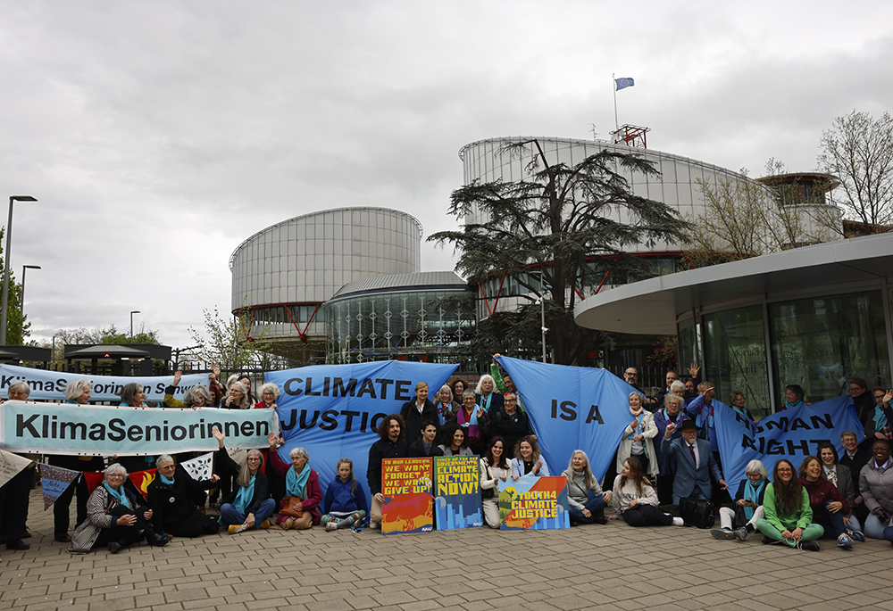 People demonstrate outside the European Court of Human Rights April 9, in Strasbourg, eastern France. The European Court of Human Rights handed down decisions in a trio of cases brought by a French mayor, six Portuguese youngsters and over 2,000 Swiss women who said their governments are not doing enough to combat climate change. (AP photo/Jean-Francois Badias)