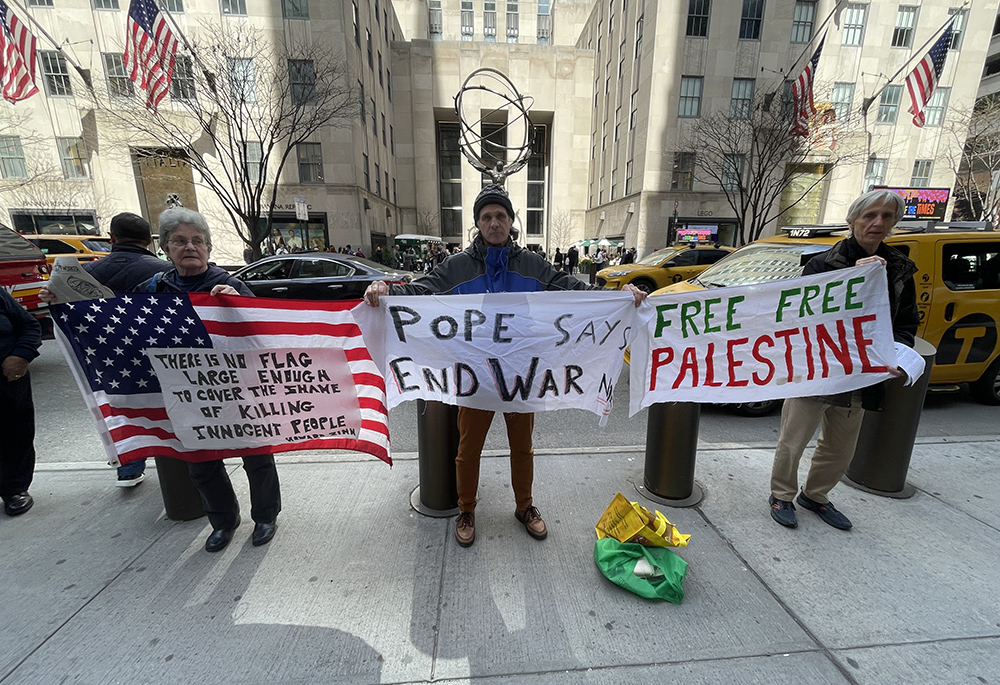 Cathy Breen, Carmen Trotta and Bernard Connaughton, members of the New York Catholic Worker community, are pictured outside St. Patrick's Cathedral during one of their Sunday witness actions. (Courtesy of Liam Myers)