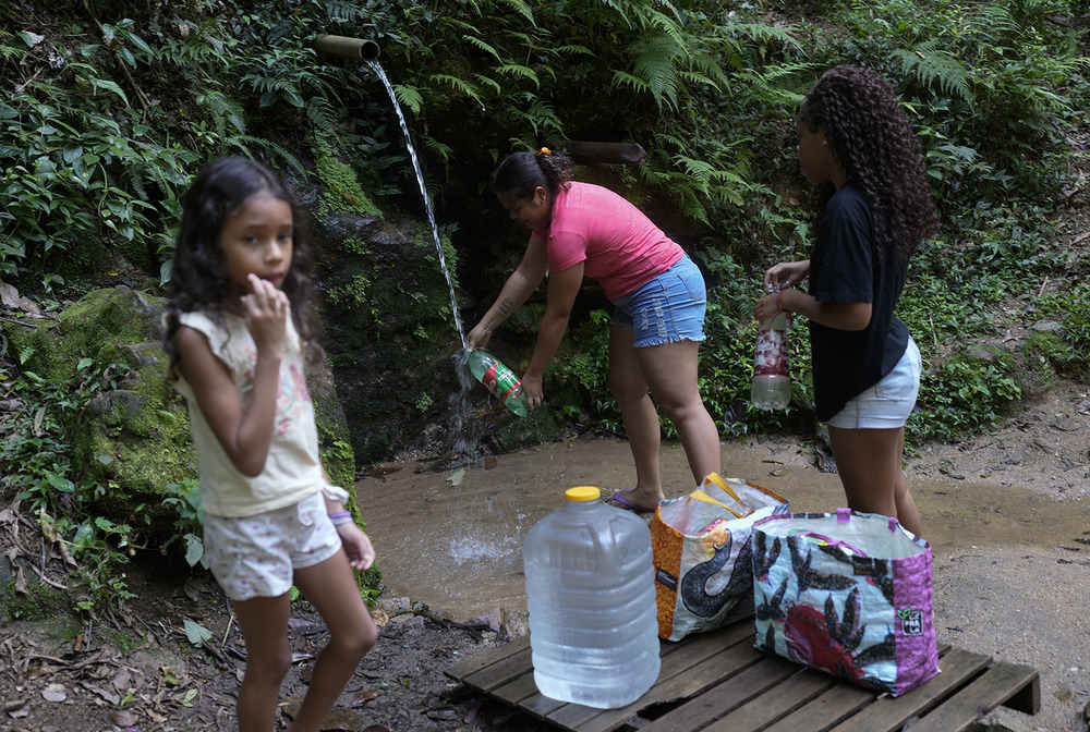 How clean water and faith go hand in hand Young girl and family gather water from stream