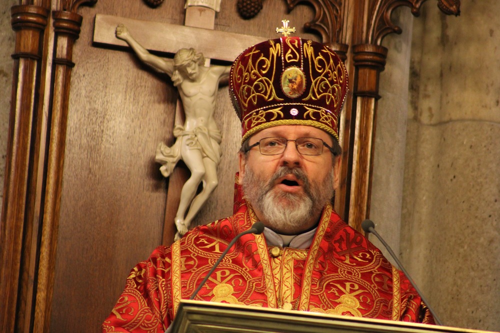 Russian persecution of Greek Ukrainian Catholics. Bishop, vested in eastern style, delivers homily from lectern, crucifix in background.
