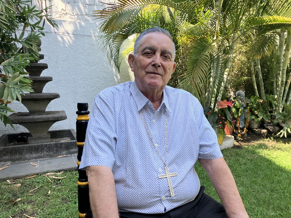 Bishop Rangel disappearance and reappearance. Casual portrait of bishop sitting in garden.