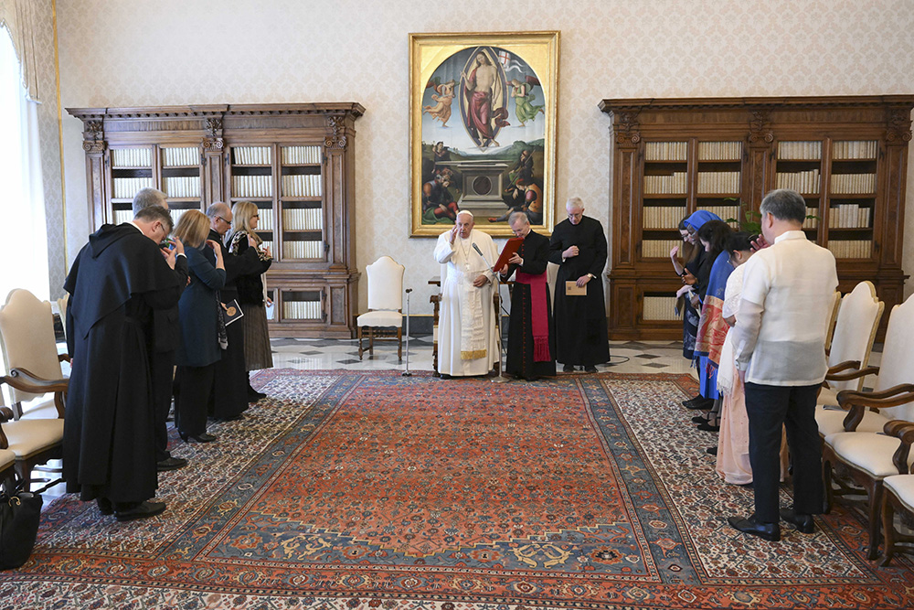 Pope Francis prays with members of the International Network of Societies for Catholic Theology in the library of the Apostolic Palace at the Vatican May 10, 2024. (CNS/Vatican Media)