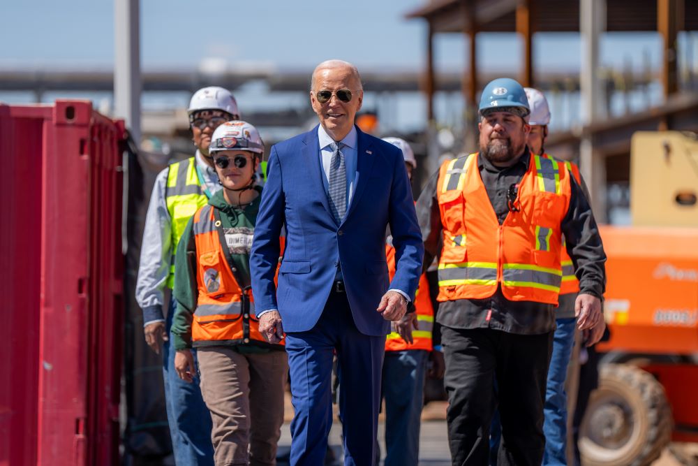 President Joe Biden and union members building Intel's Ocotillo Campus walk onstage before announcing $20 billion in investments to ramp up production of semiconductor chips in Arizona.