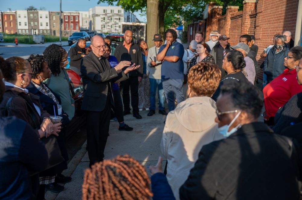 Archdiocese of Baltimore's Auxiliary Bishop Bruce Lewandowski speaks to an overflow crowd attending a special Seek the City To Come meeting for the Black Catholic community April 23, 2024, outside St. Frances Academy in Baltimore. The archdiocese released its final plan for parish planning in the city May 22.