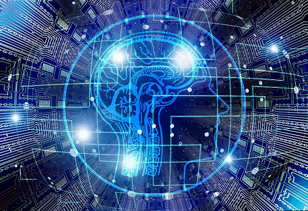 A graphic about artificial intelligence displays the profile of a human head, showing the brain, surrounding by circuit boards. (Pixabay/Gerd Altmann)