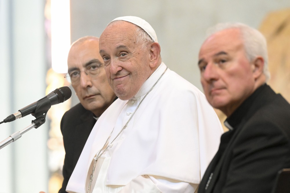 Pope Francis encourages gay seminarian Pope Francis, seated, smiles as he listens.