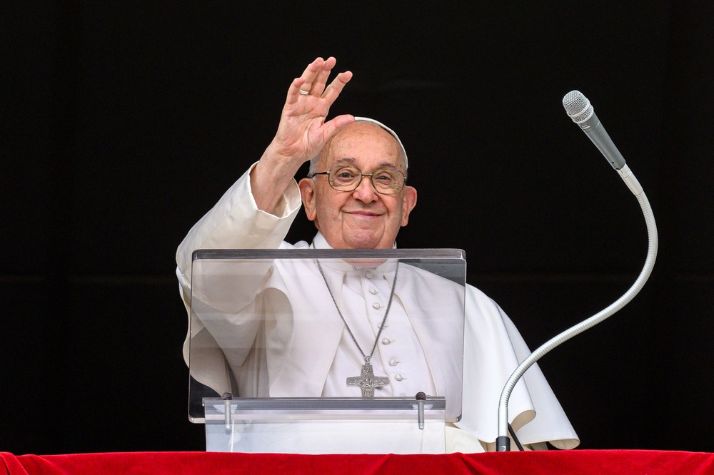 Pope Francis Angelus June 23 Pope Francis, smiling, waves from St. Peter's Square balcony
