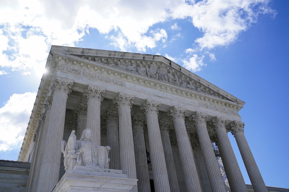 US Supreme Court Supreme Court building looms against blue sku