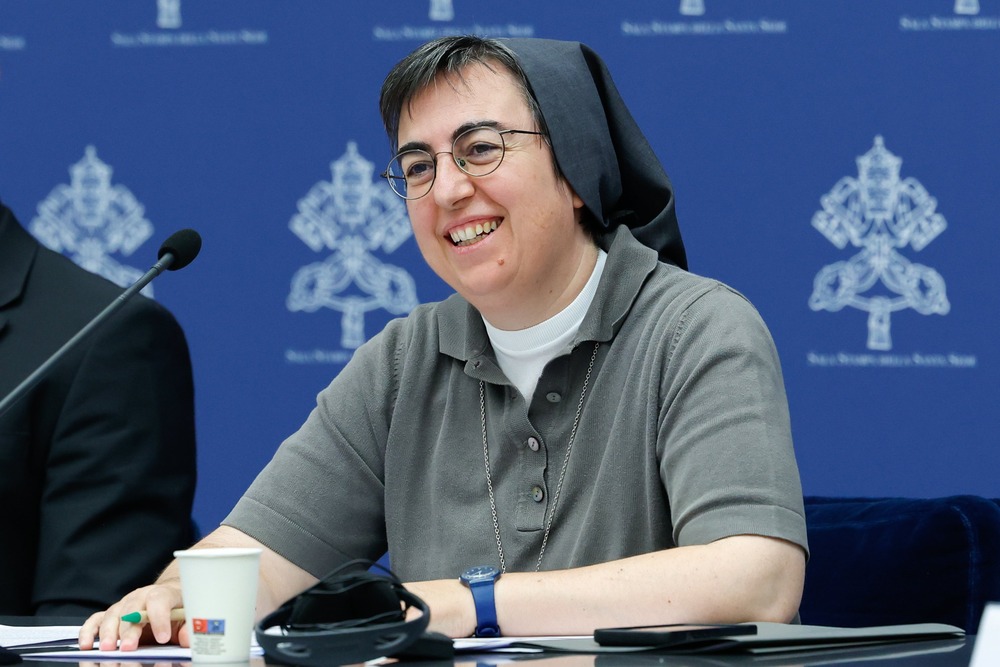Sister Alessandra Smerilli, secretary of the Dicastery for Promoting Integral Human Development Sister Smerilli smiles as she sits and listens at panel desk.