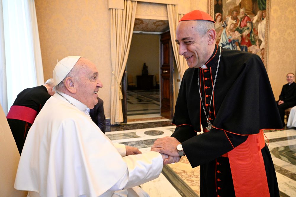 Pope Francis greets Cardinal Víctor Manuel Fernández, prefect of the Dicastery for the Doctrine of the Faith, during a meeting with members of the Pontifical Biblical Commission on April 11 in the Apostolic Palace at the Vatican.