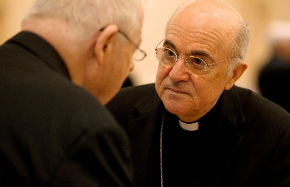 Archbishop Carlo Maria Viganò, then apostolic nuncio to the United States, talks with a U.S. bishop during the bishops' meeting in Baltimore in this Nov. 13, 2012, file photo.