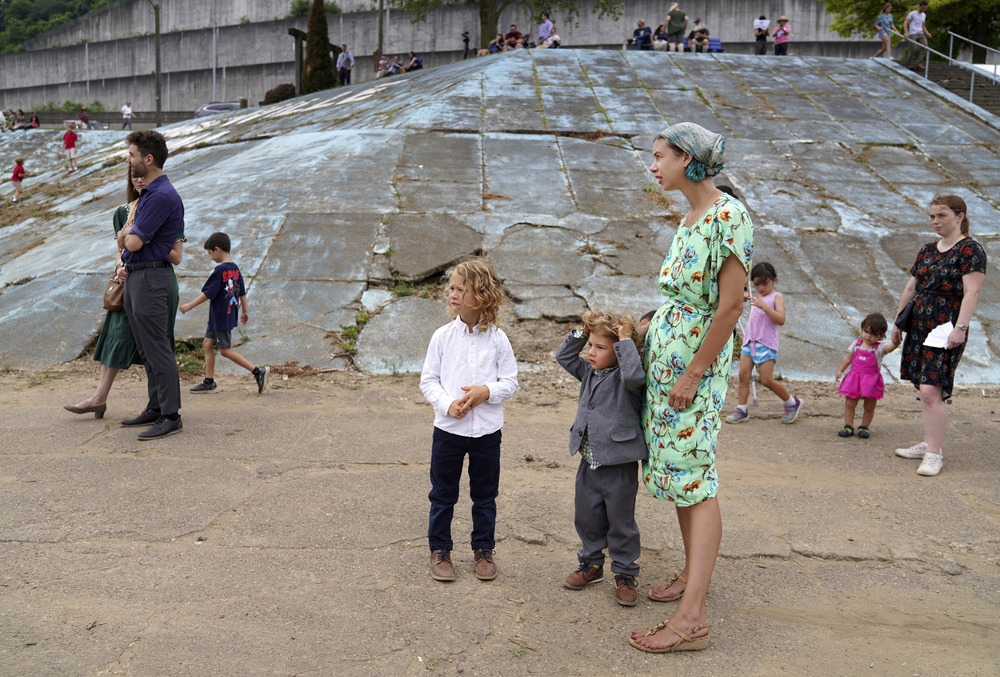 Eucharistic revival pilgrimage, Steubenville, Ohio Woman stands with two children, as others walk in background