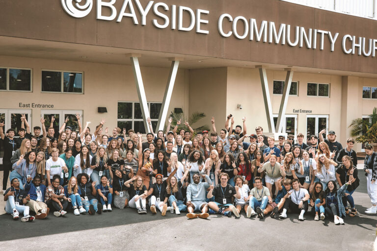 The Commission on Faith-based Colleges and Universities Large group of people stand in front of church building