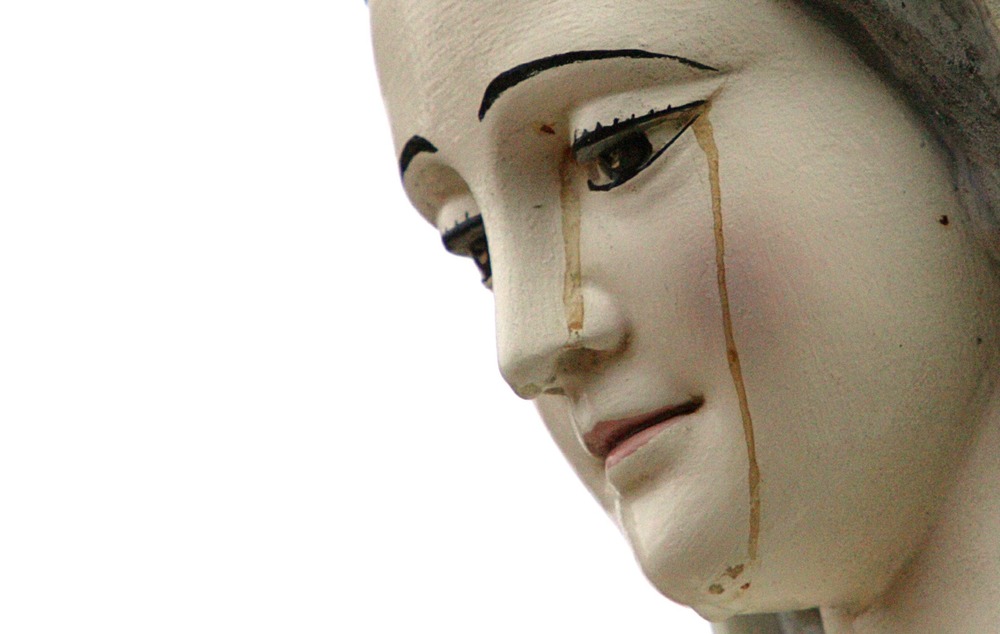 Sacramento "bleeding" Madonna statue. Marian statue up close, brownish liquid seeps down face.