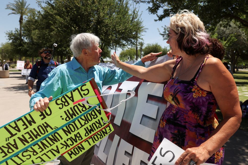 An abortion opponent and a supporter of legal abortion argue outside the Arizona State Capitol in Phoenix as the state Senate votes to repeal its near total ban on abortion May 1. An abortion opponent and a supporter of legal abortion argue outside the Arizona State Capitol in Phoenix as the state Senate votes to repeal its near total ban on abortion May 1.