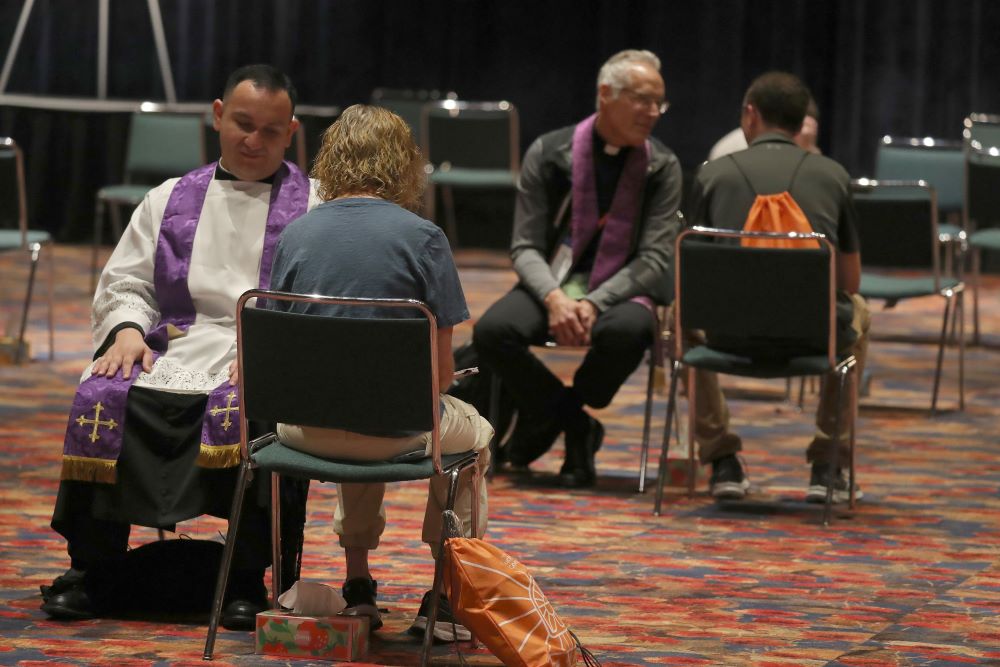 Priests hear confessions at eucharistic congress. Priests hear confessions at eucharistic conference.