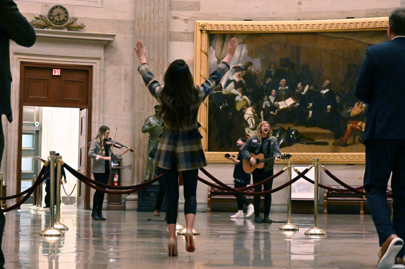 Sean Feucht U.S. Capitol Rotunda concert, 2023 Boebert pictured from behind, Feucht plays guitar in background.