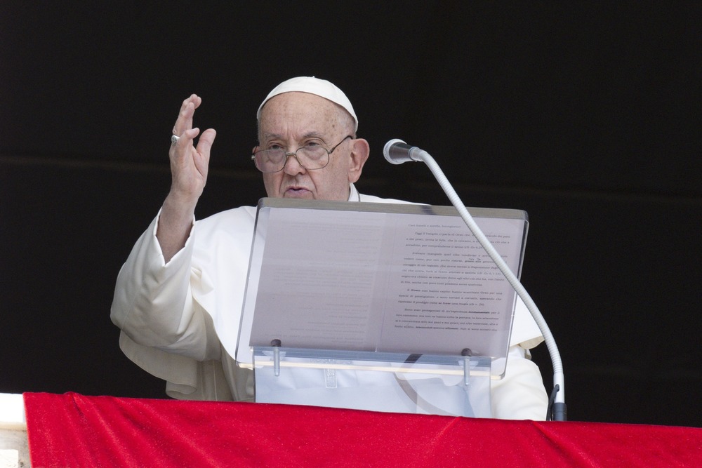 Pope Francis, Angelus, St. Peter's Square, August 4, 2024. Pope at lectern with hand raised in blessing.