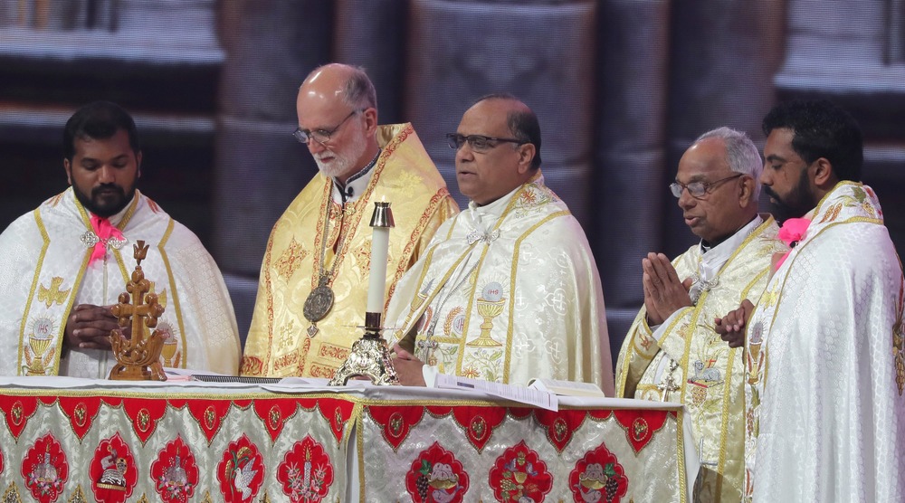Syro-Malabar Bishop Joy Alappatt and Metropolitan Archbishop Borys A. Gudziak of the Ukrainian Catholic Archeparchy of Philadelphia, 2024. Bishops and other clergy stand around altar during liturgy; all vested.