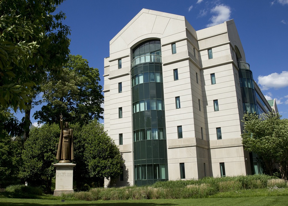 USCCB headquarters, Washington D.C, 2017. A tall, modern stone and glass building.
