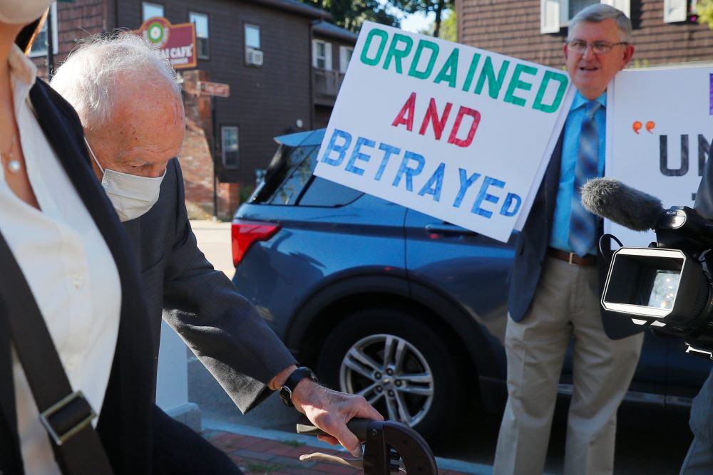 Protesters greet former Cardinal Theodore McCarrick as he arrives at court. Protesters greet former Cardinal Theodore McCarrick as he arrives at court.