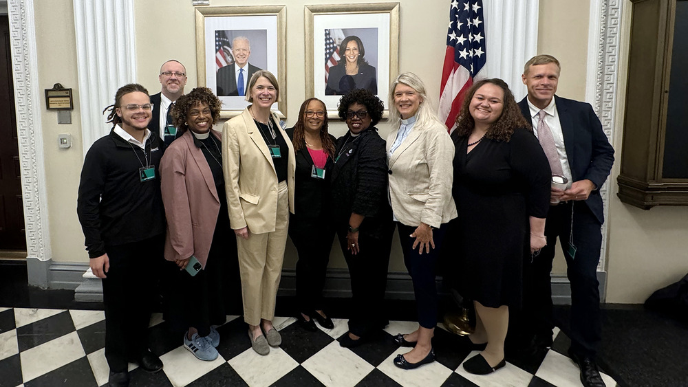 White House Faith Leaders Convening on Climate, Clean Energy, and Environmental Justice, Aug. 13, 2024. White House, Washington D.C. A group of nine people stands in front of America flag and portraits of President Joe Biden and Vice-President Kamala Harris.