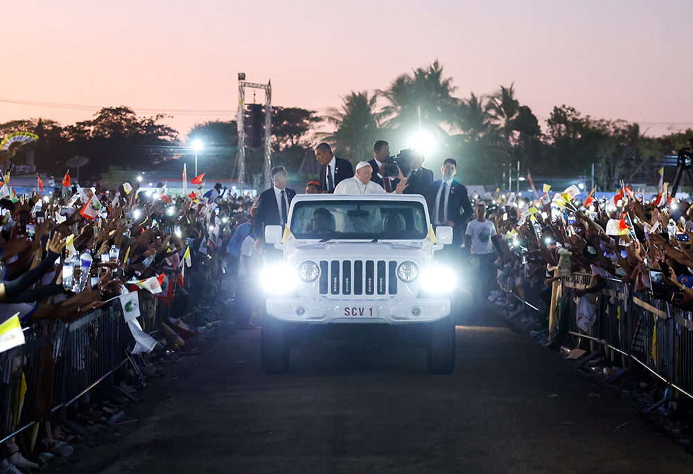 Pope Francis waves to the faithful from the popemobile as he circles the crowd following an outdoor Mass in Tasitolu, East Timor, on Sept. 10. (CNS/Lola Gomez) Pope Francis waves to the faithful from the popemobile as he circles the crowd following an outdoor Mass in Tasitolu, East Timor, on Sept. 10. (CNS/Lola Gomez)