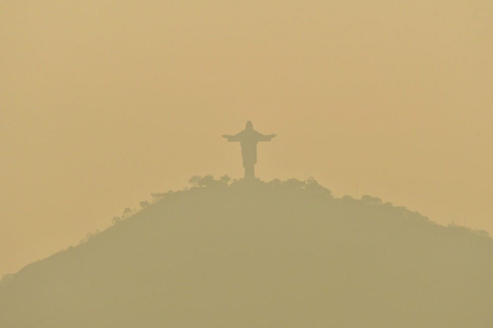 Statue of Christ of Peace atop San Pedro Hill Sept. 10, 2024. Monumental hilltop statue obscured by sickly, yellow smoke.
