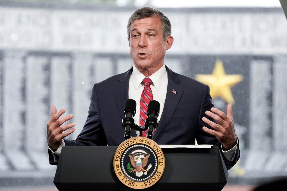 Delaware Gov. John Carney, May 20, 2021. Carney stands at a podium speaking.