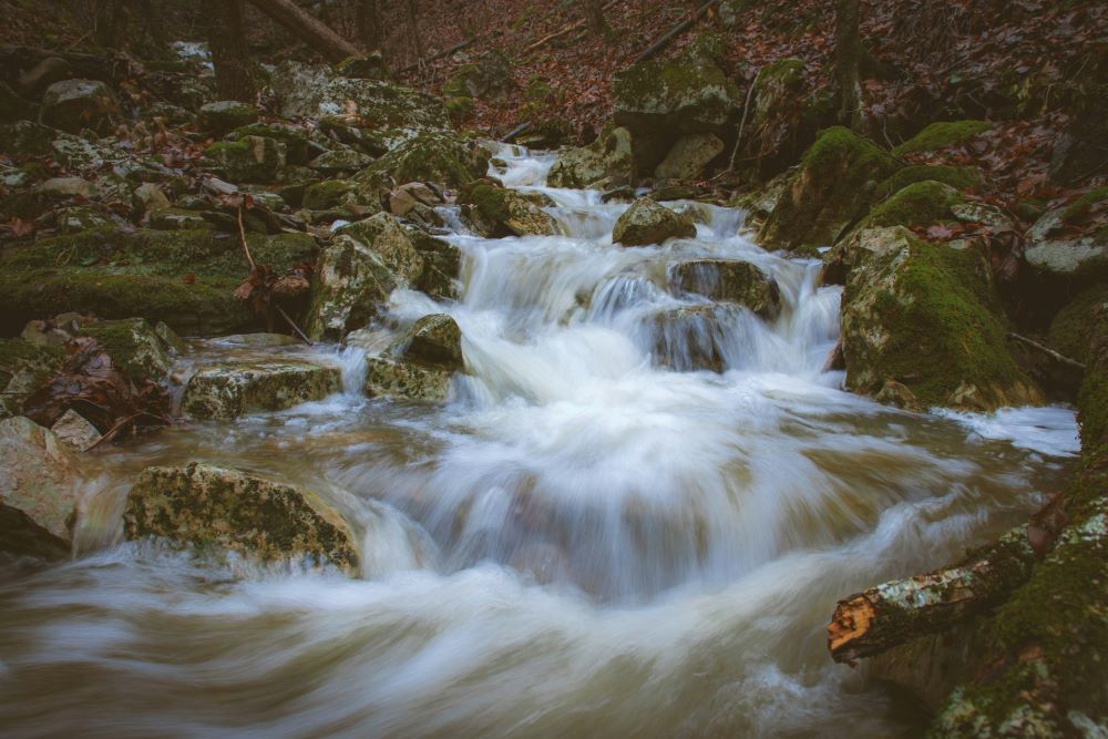 Water flows through rocks. Water flows through rocks.