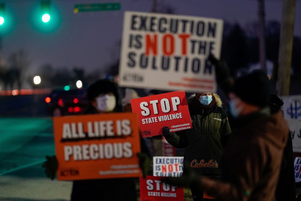 Demonstrators gather outside the federal prison in Terre Haute, Indiana, holding signs opposing the death penalty. Demonstrators gather outside the federal prison in Terre Haute, Indiana, holding signs opposing the death penalty.