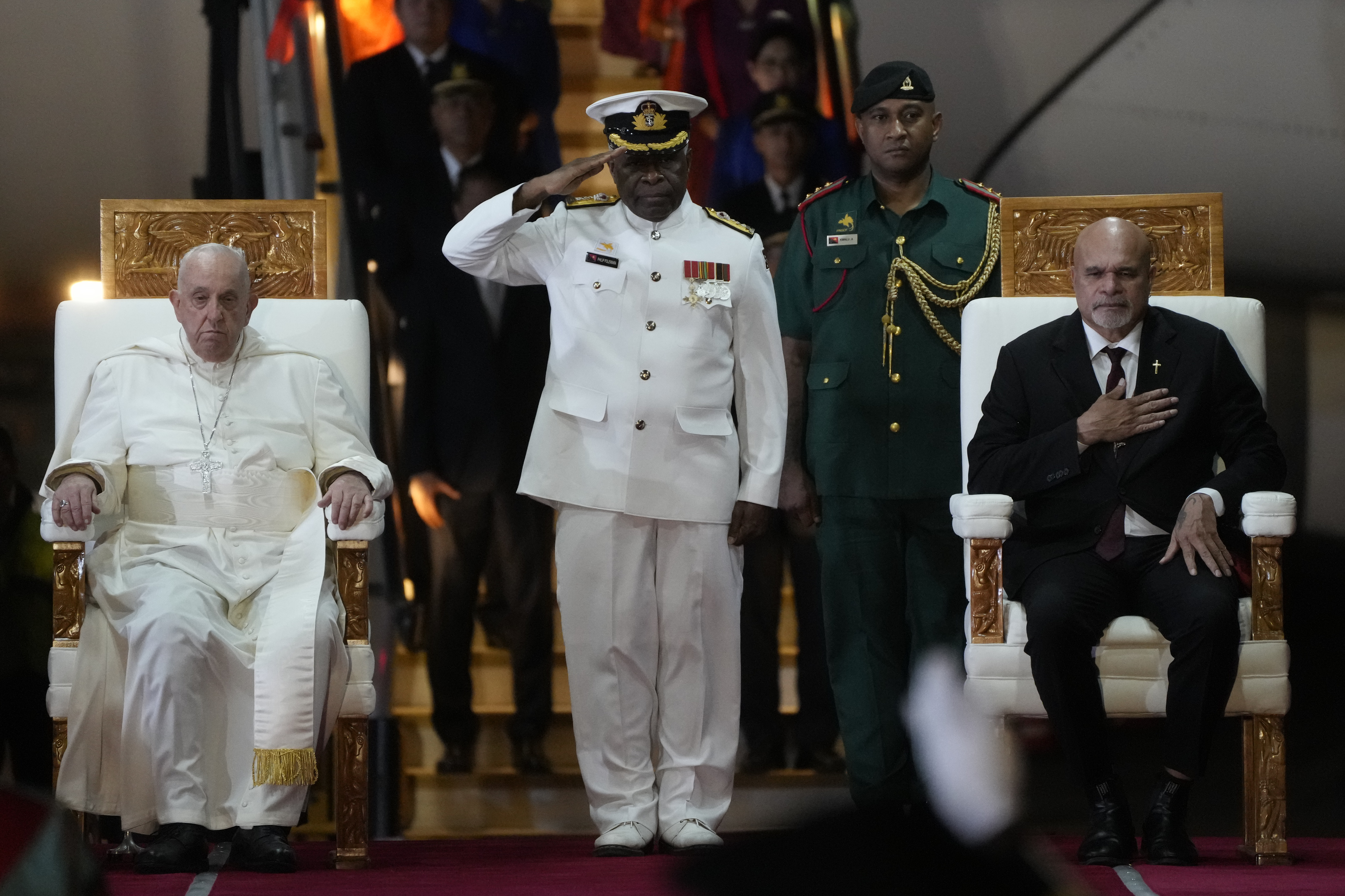 Pope Francis, left, is welcomed by Papua New Guinea's deputy Prime Minister John Rosso, right, and rear-Admiral Philip Polewara, center, as he arrives at Port Moresby's "Jackson" International Airport, Sept. 6, 2024. As a second leg of his 11-day trip to Asia and Oceania Pope Francis' visit to Papua New Guinea will take him to a remote part of the South Pacific island nation where Christianity is a recent addition to traditional spiritual beliefs developed over millennia. (AP/Gregorio Borgia) Pope Francis, left, is welcomed by Papua New Guinea's deputy Prime Minister John Rosso, right, and rear-Admiral Philip Polewara, center, as he arrives at Port Moresby's "Jackson" International Airport, Sept. 6, 2024. As a second leg of his 11-day trip to Asia and Oceania Pope Francis' visit to Papua New Guinea will take him to a remote part of the South Pacific island nation where Christianity is a recent addition to traditional spiritual beliefs developed over millennia. (AP/Gregorio Borgia)