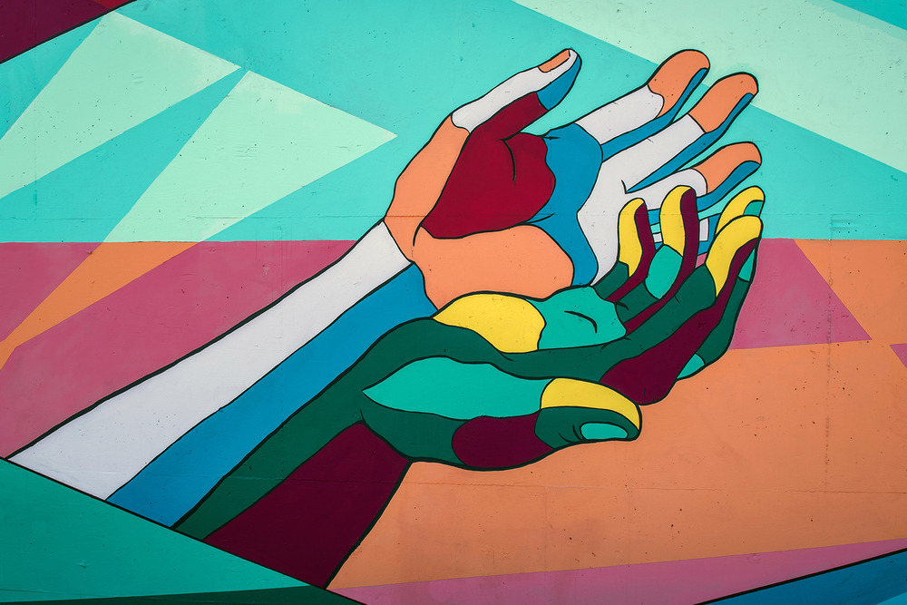 Caring hands image. Colorful graphic of two outstretched hands.