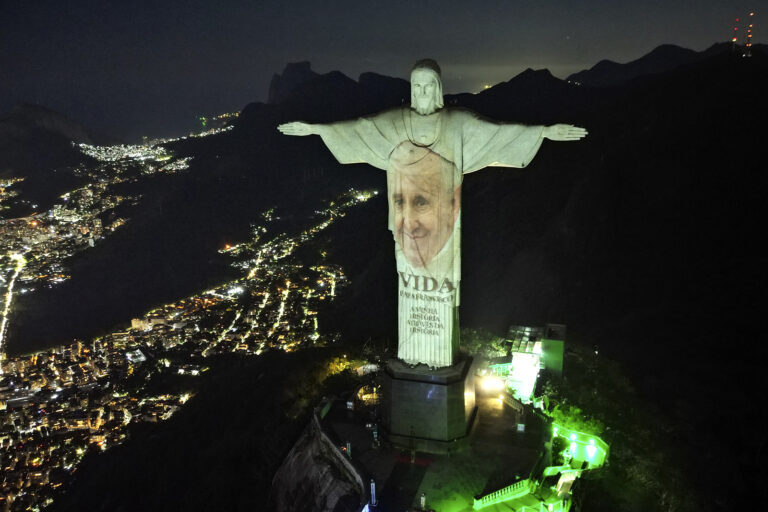 Christ the Redeemer bearing Pope Francis' image, Rio de Janeiro, May 23, 2024. Pope Francis' face projected at night onto monumental statue.