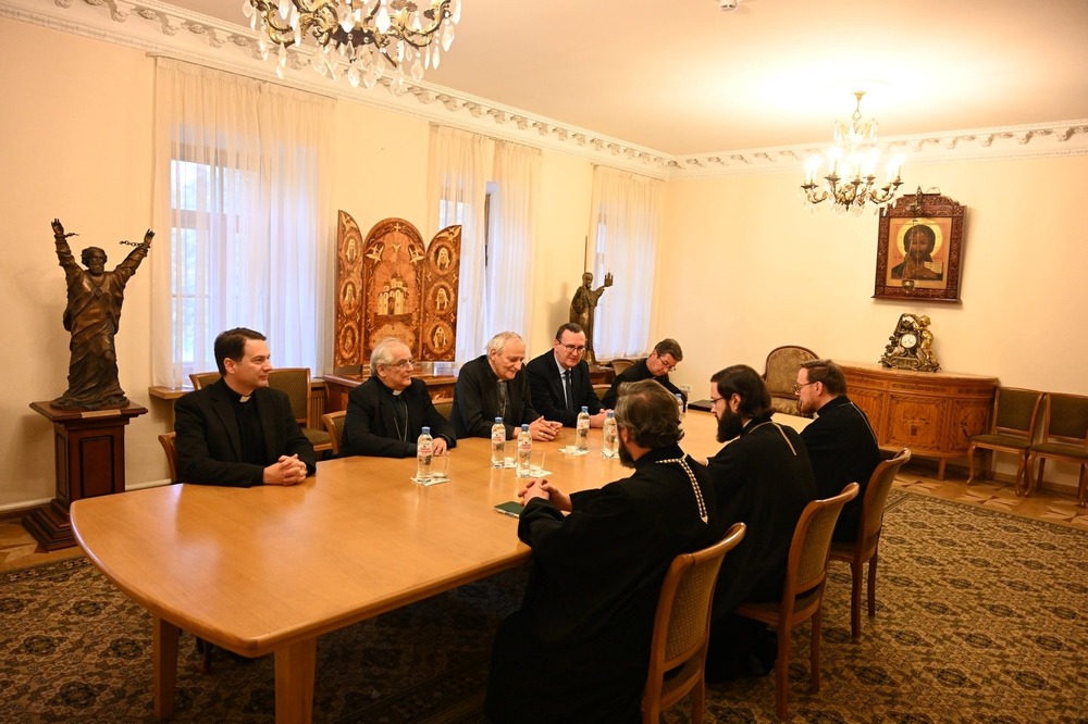 Cardinal Matteo Zuppi meeting with Russian delegation, Moscow, Oct. 16, 2024. Prelates sit around table in conference room.