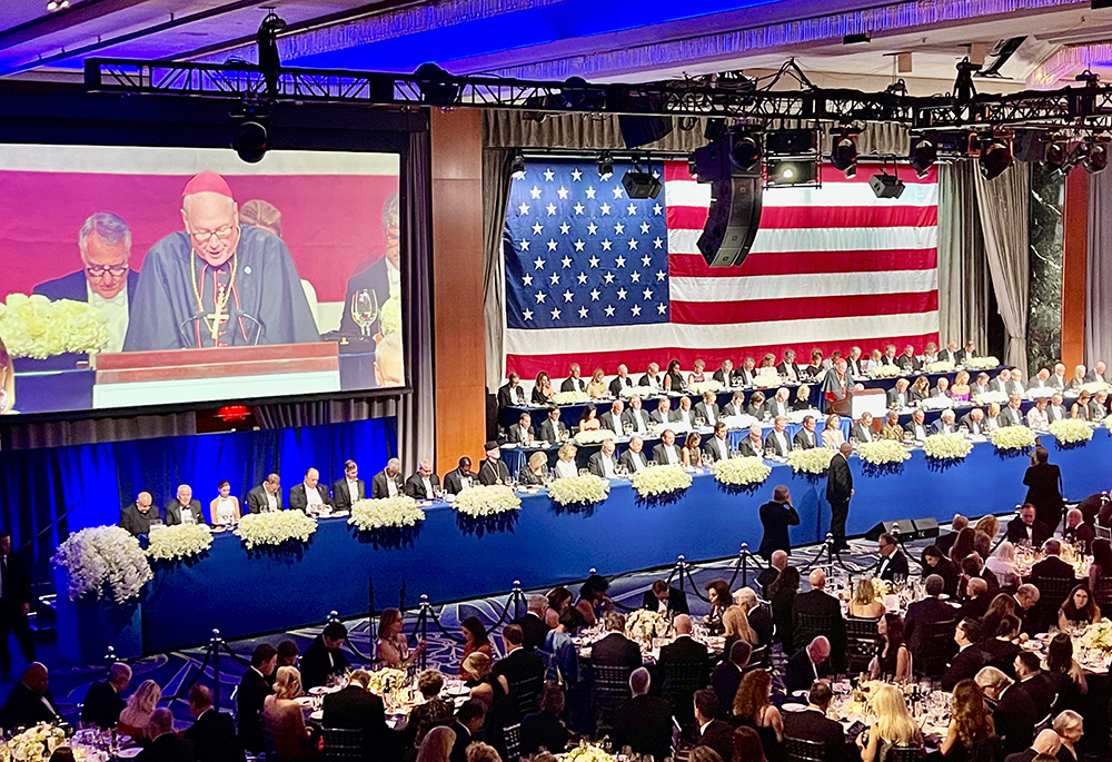New York Cardinal Timothy Dolan leads a prayer at the Alfred E. Smith Memorial Foundation Dinner Oct. 17, the fundraiser for Catholic charities in New York at the New York Hilton Midtown. (NCR photo/Camilllo Barone)