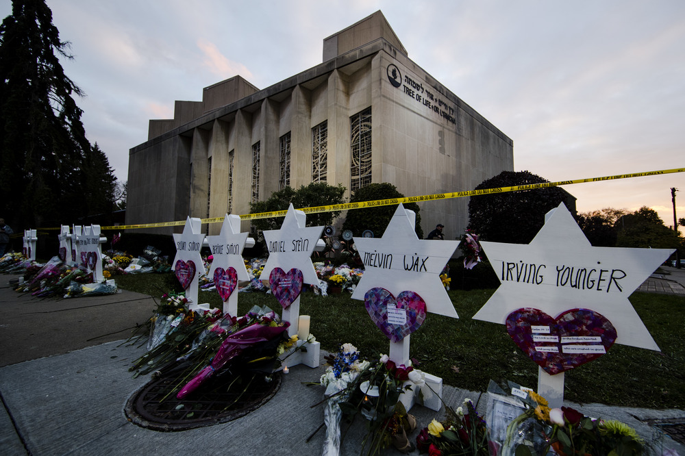 Tree of Life Synagogue, Pittsburgh, Oct. 29, 2024. Small markers bear the names of the killed, in the background is the synagogue still marked with crime scene tape,