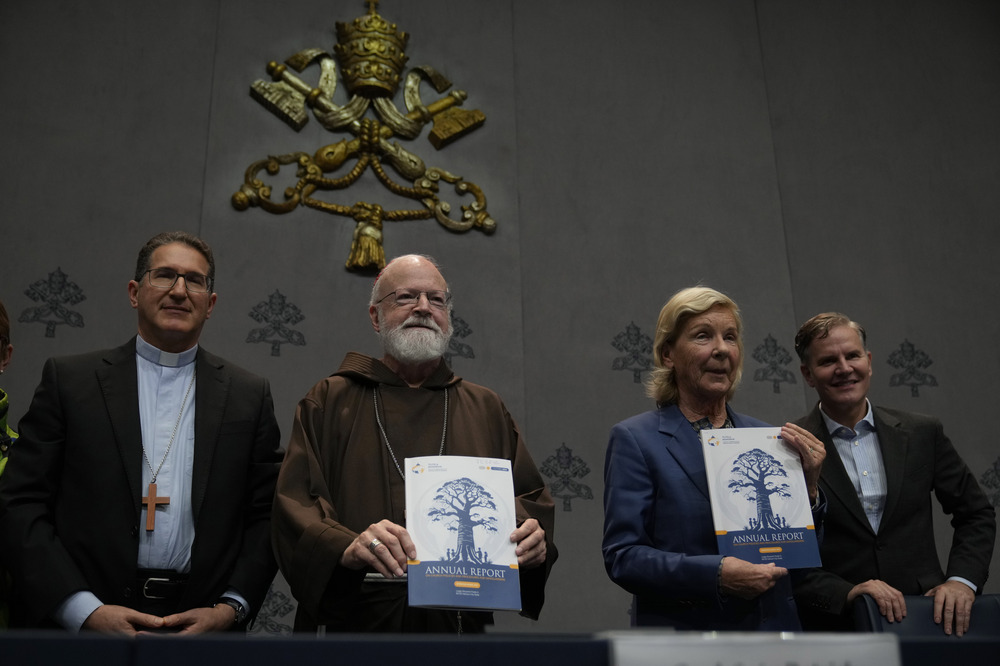 Pontifical Commission for the Protection of Minors first annual global report press conference, Vatican City, Oct. 29, 2024. The four stand, center two hold copy of report.