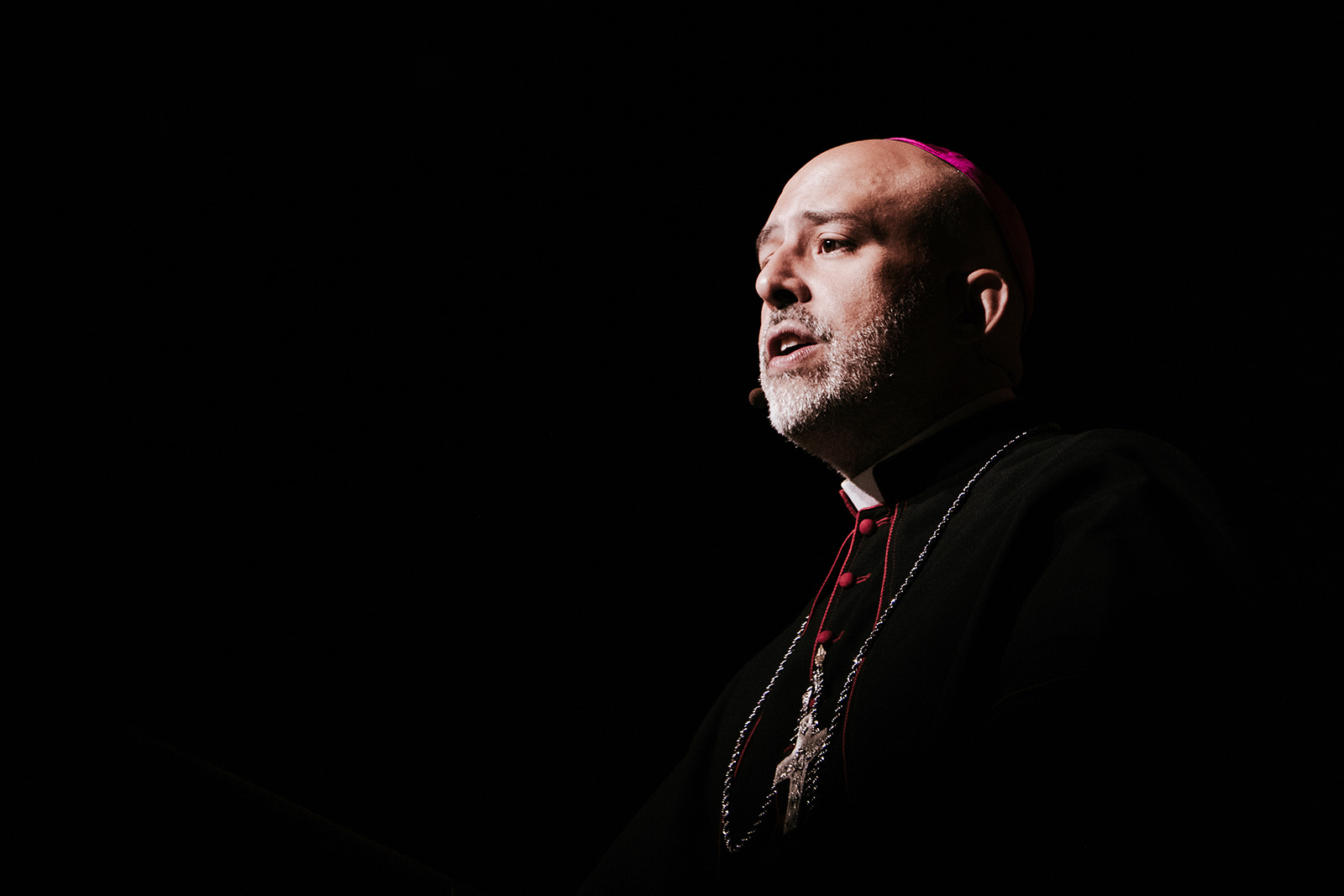 Auxiliary Bishop of New York Joseph Espaillat, National Eucharistic Congress, Indianapolis, July 20, 2024. The bishop is shown in sharp chiaroscuro.