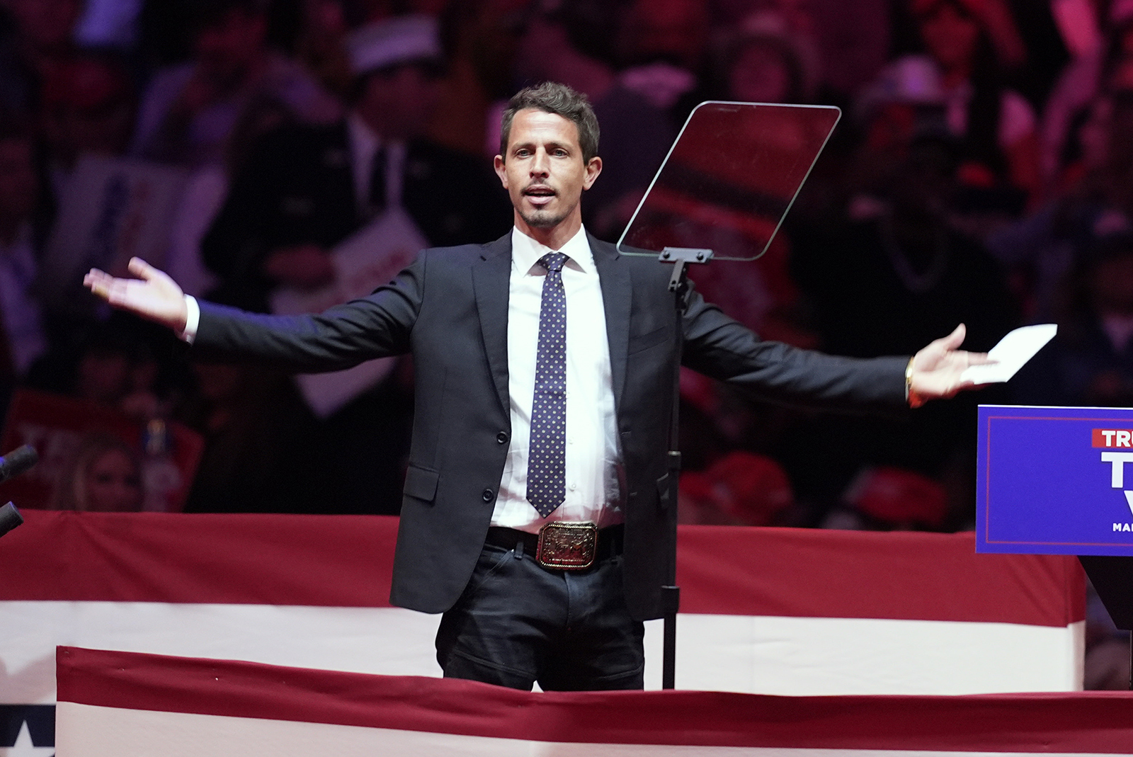 Tony Hinchcliffe, Trump rally, New York City, Oct. 27, 2024. Hinchcliffe stands with arms open wide on stage.
